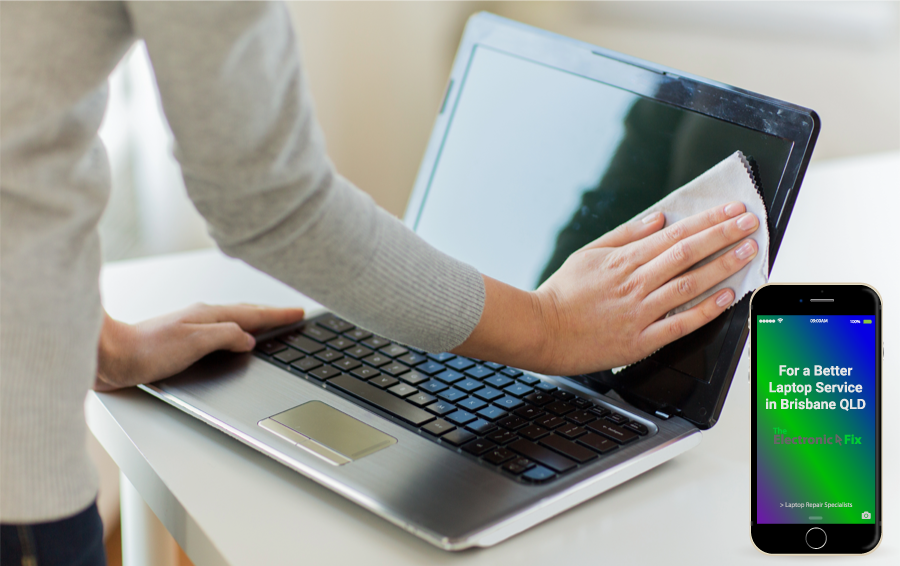 person wiping cleaning laptop screen